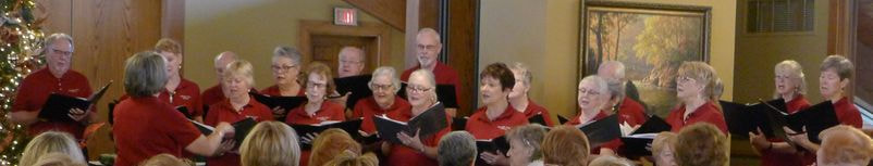 Heritage Oaks Chorus singing at the December meeting.