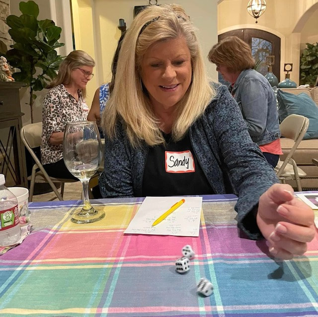 Ready to Roll Bunco in April had a great meal and threw dice to pick winners!